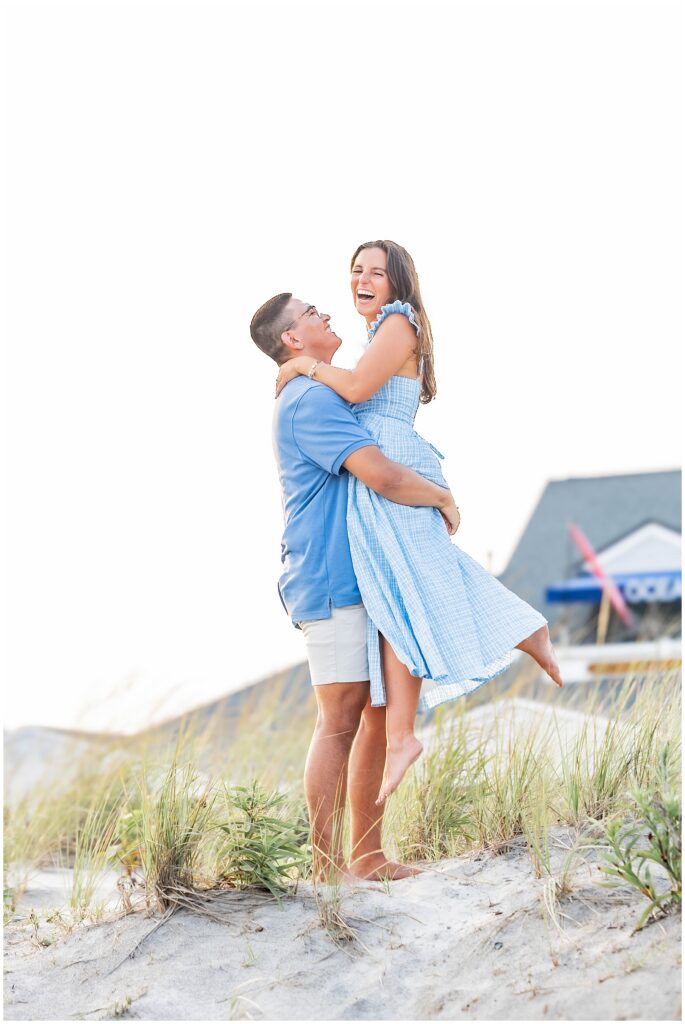 Engaged couple walking hand in hand through Ocean City NJ