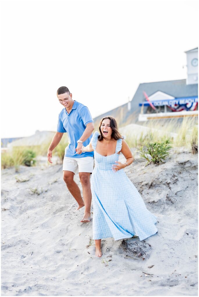 Engaged couple walking hand in hand through Ocean City NJ